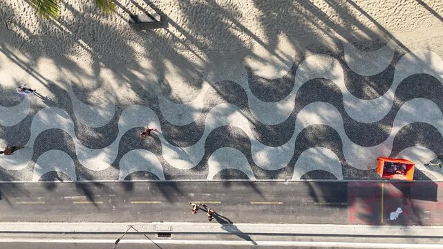 Runners on Copacabana promenade with wave mosaic, aerial view, Rio
