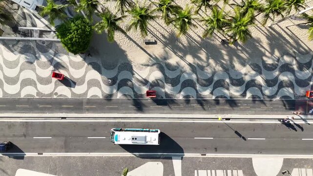 Top-down drone shot following bus in beachfront traffic, Copacabana, Rio