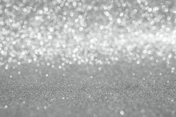 Abstract silver glitter sparkle texture with bokeh background © Kwangmoozaa
