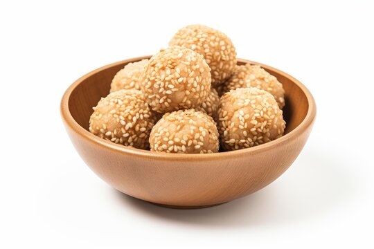 Sesame balls, a popular indonesian snack known as onde onde, served in wooden bowl, showcasing their golden texture and nutty aroma