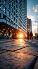 Obraz premium Urban Sunset Glow: Pedestrians Silhouetted Against City Building Facade
