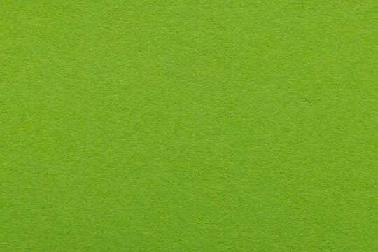 Green paper texture background with natural fiber details,High-resolution close-up of vibrant lime green construction paper showing a grainy, organic fibrous texture. Ideal for eco-friendly concepts, 