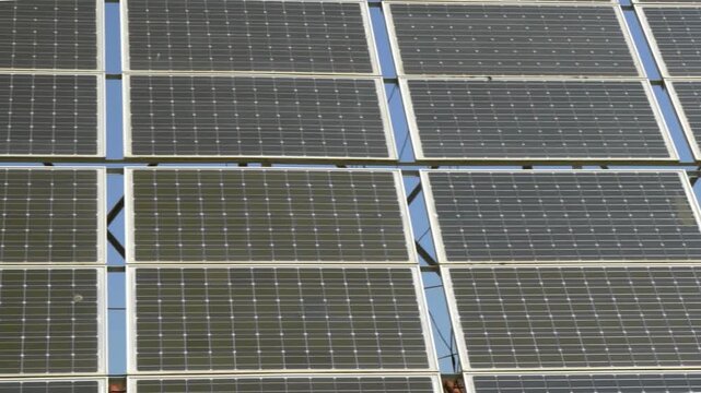 Macro Texture of Polycrystalline Silicon Solar Cell showing Photovoltaic Wafer Grid and Sun Flare Reflection for Clean Energy Technology