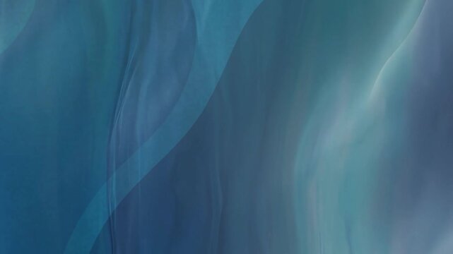 Flowing fabric with blurred oval designs in blue shades.