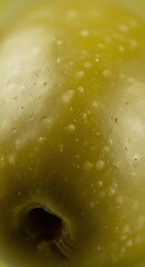 Close-Up View of a Fresh Green Apple with Water Droplets on Smooth Skin