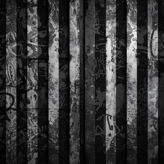 Fototapeta premium A composition of vertical lines on a worn surface reveals intriguing graffiti, creating an unusual artistic canvas full of stories.