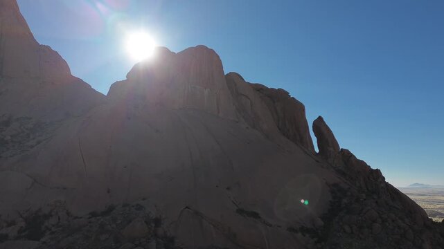 Spitzkoppe, or Spitzkop, is a unique pink granite rock formation in the landscape of Damaraland, Namibia, Africa. Aerial view.