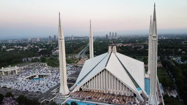 Faisal Mosque with Crowded Courtyard and Margalla Hills in Islamabad, Pakistan