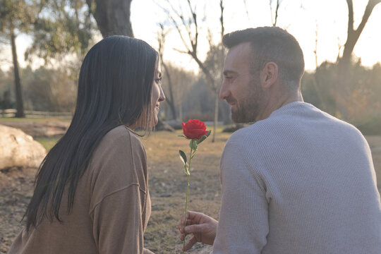 Couple in love sitting back to back in nature