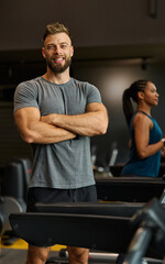 Fototapeta premium Portrait of a young man and a black woman exercising in a gym, running using thereadmill machine equipment, healthy lifestyle and cardio exercise at fitness club concepts