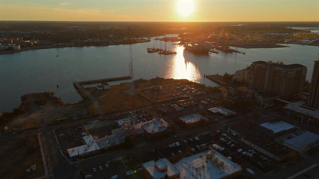 Dramatic sunset aerial of Norfolk Virginia with glowing waterfront and port