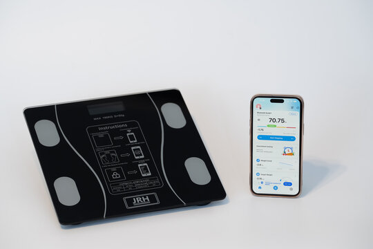 Bucharest Romania 1 February 2026. JRH digital scale with smartphone app for accurate weight measurement, modern design on a white background