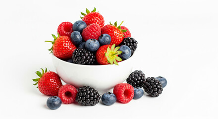 Obraz premium A vibrant assortment of mixed berries spills artfully from a crisp white bowl, showcasing the natural beauty and freshness of these delicious fruits.