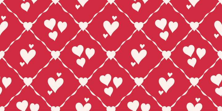 Romantic seamless pattern featuring soft cream hearts arranged in a diamond lattice over a bold red background
