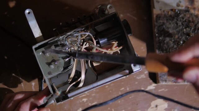 repair of a microcircuit with a soldering iron and a tweezers close-up