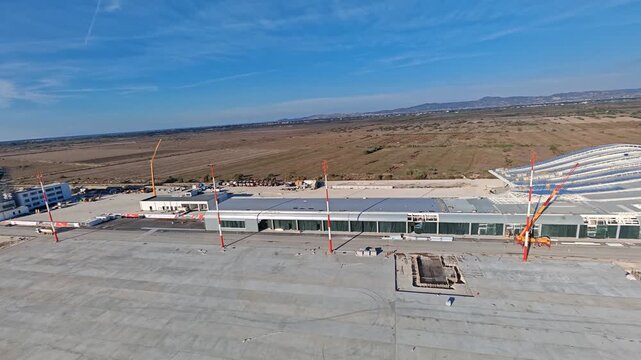 Aerial view of the new international airport under construction in Vlore Albania, a project known for repeated delays, showing unfinished runways, buildings, and large scale infrastructure development