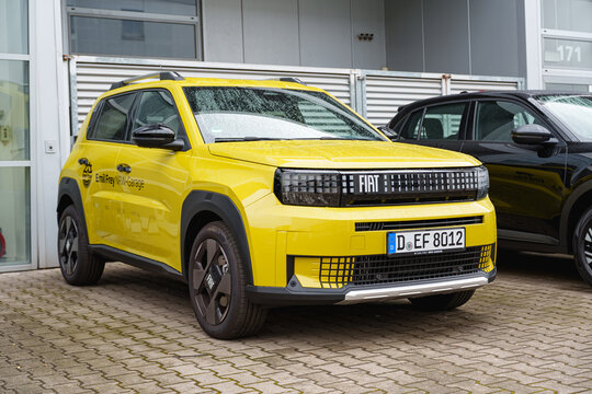 Yellow Fiat Grande Panda compact SUV parked outside the dealership building
