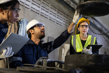 Serious team of diverse engineer workers inspecting industrial tunnel construction site with...