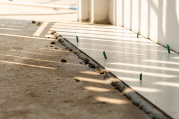 Obraz premium Home renovation close-up tile installation process in a residential construction environment