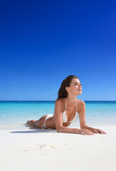 Woman on the beach in white bikini