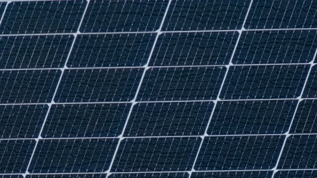 Macro Texture of Polycrystalline Silicon Solar Cell showing Photovoltaic Wafer Grid and Sun Flare Reflection for Clean Energy Technology
