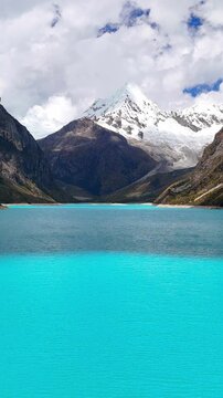  Vertical aerial view of the turquoise waters of Laguna Par&oacute;n, with snow-capped peaks of the Cordillera Blanca in Huaraz, Peru.