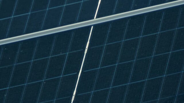 Macro Texture of Polycrystalline Silicon Solar Cell showing Photovoltaic Wafer Grid and Sun Flare Reflection for Clean Energy Technology
