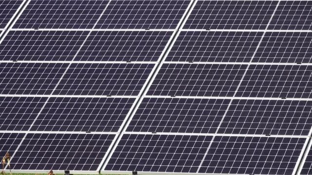 Macro Texture of Polycrystalline Silicon Solar Cell showing Photovoltaic Wafer Grid and Sun Flare Reflection for Clean Energy Technology