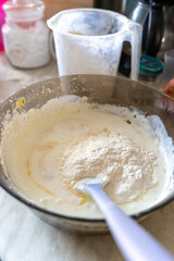 Fototapeta premium making pie dough in a dark glass bowl