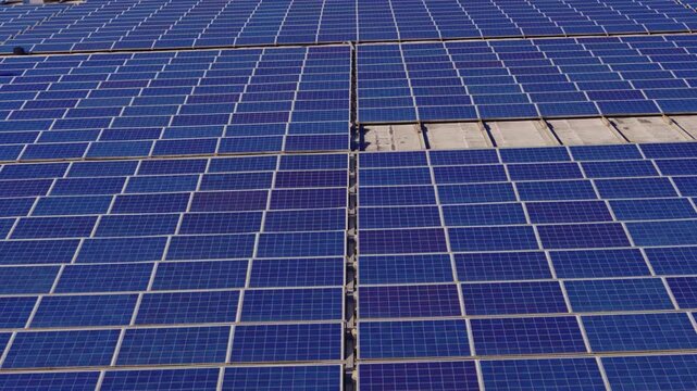 Macro Texture of Polycrystalline Silicon Solar Cell showing Photovoltaic Wafer Grid and Sun Flare Reflection for Clean Energy Technology