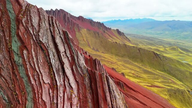 Aerial drone view of Pallay Punchu with multicolored ridges. At 4,791 meters, people enjoy the summit view. Cusco, Peru	