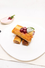 Homemade Cherry Crepes on White Plate