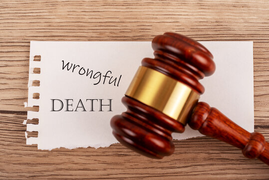 Judge gavel over wrongful death text, legal lawsuit, justice and compensation concept.