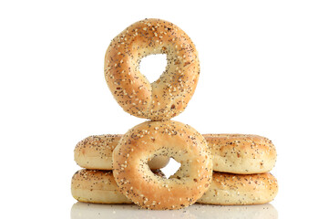 closeup of pile of everything seasoned bagels on white