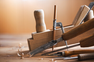 Woodworking tools on wooden workbench in carpentry workshop. Joinery and craft carving tools for wood processing.