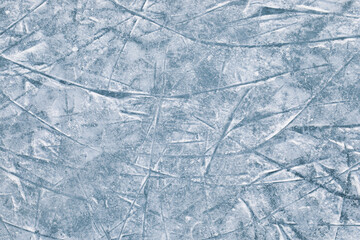 Ice hockey rink texture with skate marks or scratches. Outdoor area icy background closeup, top view