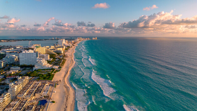 Breathtaking Aerial View of Turquoise Ocean Waves Crashing Along the Pristine Sandy Beaches of Cancun Hotel Zone, Mexico in a Vibrant Summer Paradise