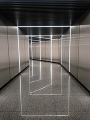 Obraz premium Futuristic corridor with LED light frames and reflective floor