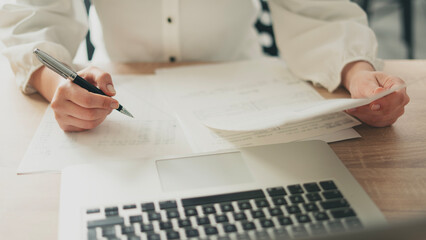 The businesswoman is reviewing the documents