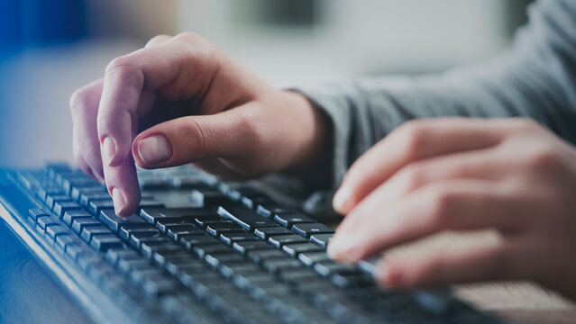 Female hands typing on keyboard