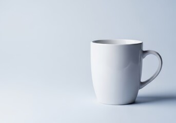 Fototapeta premium Isolated clean white ceramic mug sitting on a solid background, showcasing simplicity, minimalism, and elegance for beverage promotion or template use, elegance, serving, household