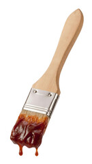 Dripping barbecue sauce on a wooden basting brush