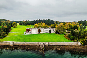 Obraz premium Autumn over Plas Newydd House from a drone, Gardens and Parkland, Llanfairpwllgwyngyll, Anglesey, Wales, UK