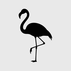 Naklejka premium Black silhouette of a flamingo standing on one leg, with graceful curved neck on gray background