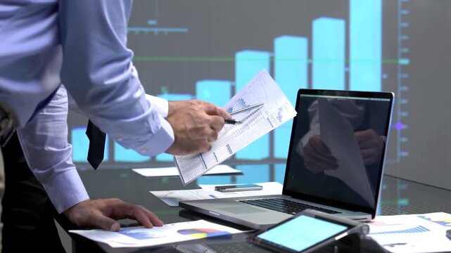 Business professionals analyzing data on a laptop