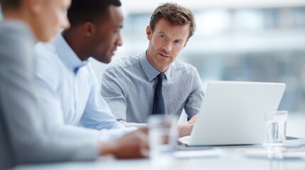 Obraz premium business team discussing corporate project around laptop in office, teamwork and digital workflow