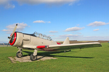 Light airplane standing on a grass runway	