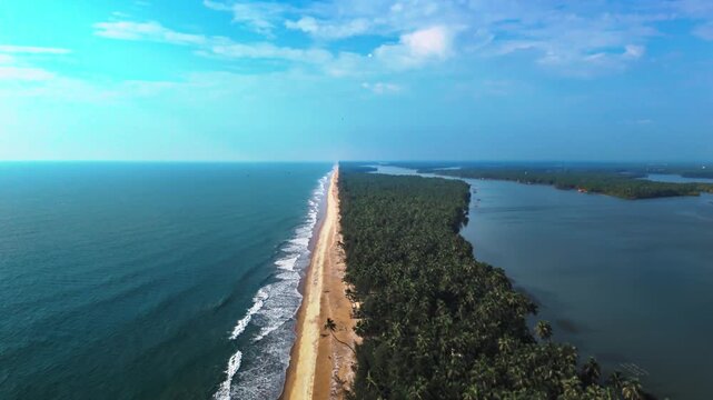 Aerial drone view of the long sandy beach at Kavvayi Beach, surrounded by greenery and calm Arabian Sea waves.