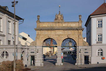 Obraz premium A stone gate with two arches. The entrance to a brewery courtyard in the Czech Republic