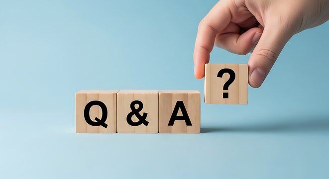 Hand places question mark block next to Q and A wooden blocks question and answer